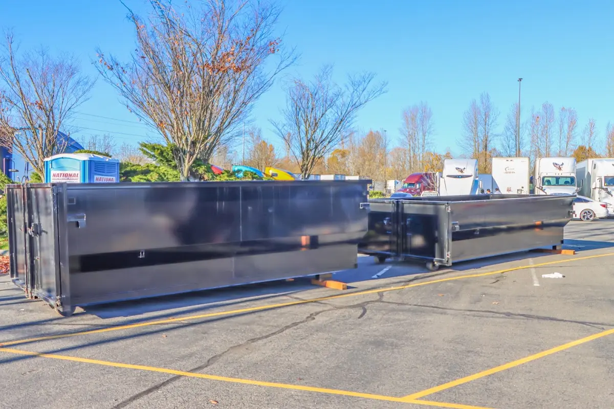 Professional dumpster rental service with roll-off container on residential driveway in San Juan Capistrano